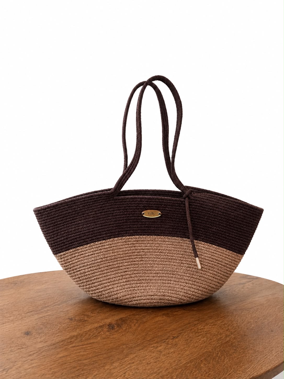 ViBo handwoven rope tote bag in the Espresso & Sand colorway, on a wooden table